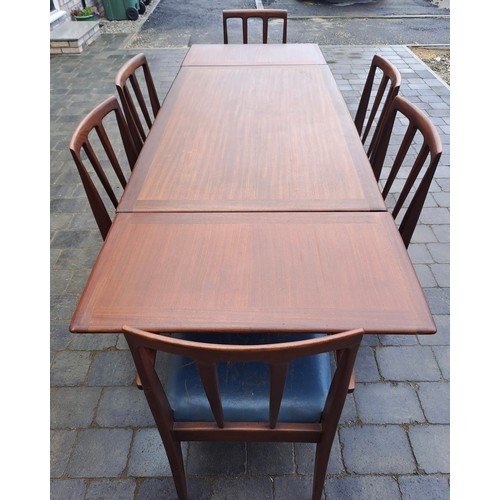 98 - A mid 20thC teak extending dining table and six chairs including two with arms. Table size open 69cm... 