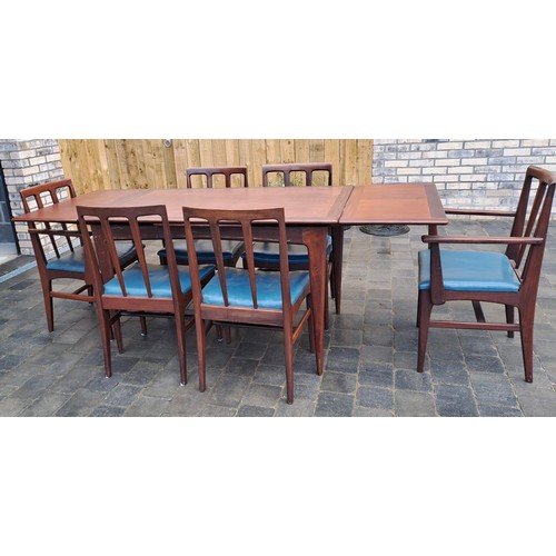 98 - A mid 20thC teak extending dining table and six chairs including two with arms. Table size open 69cm... 