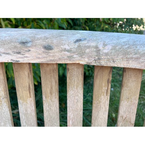 9 - Two serpentine fronted teak garden benches. 153cm w x 56cm d x 80cm h.