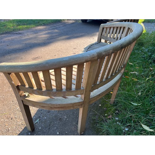 9 - Two serpentine fronted teak garden benches. 153cm w x 56cm d x 80cm h.