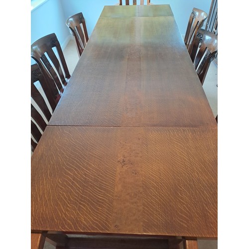 103 - An early 20thC Arts and crafts style dining table with eight chairs. 76cm h x 168cm l (closed) 260cm... 