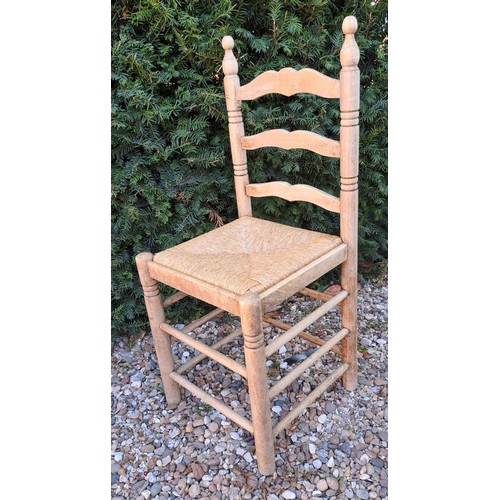 101 - Six rush seated ladder backed dining chairs. 95cm h x 40cm w x 38cm d.