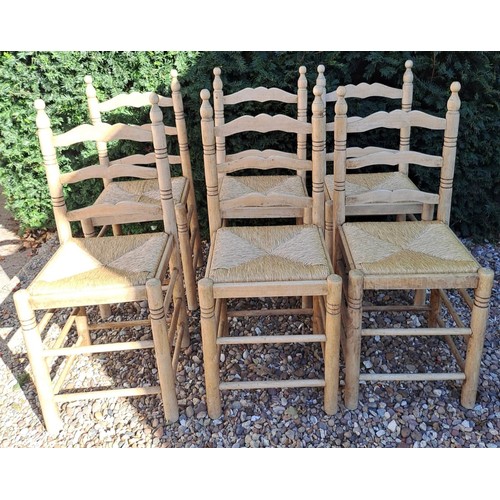 101 - Six rush seated ladder backed dining chairs. 95cm h x 40cm w x 38cm d.