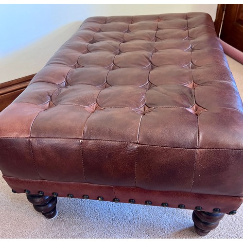 107 - Brown leather footstool. 85cm w x 55cm d x 38cm h.