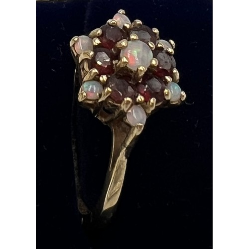 661 - A 9 carat gold garnet and opal cluster ring. Size R, weight 3.6gm.