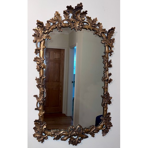 1155 - A 20thC decorative gilt framed wall mirror. 92cm h x 55cm w.