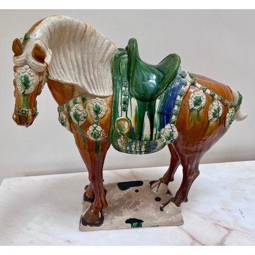 1054 - Two 20thC ceramic Tang horses. The larger coloured glazed horse with large chip to base, 63cm h x 59... 