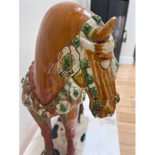 1054 - Two 20thC ceramic Tang horses. The larger coloured glazed horse with large chip to base, 63cm h x 59... 