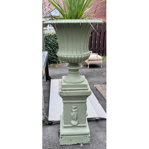 8 - A 19thC cast iron garden urn on reconstituted stone base. 153cm h x 67cm d to top of urn.