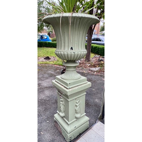 8 - A 19thC cast iron garden urn on reconstituted stone base. 153cm h x 67cm d to top of urn.