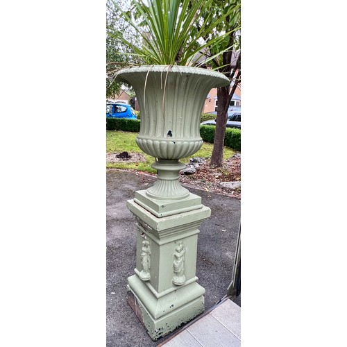 8 - A 19thC cast iron garden urn on reconstituted stone base. 153cm h x 67cm d to top of urn.