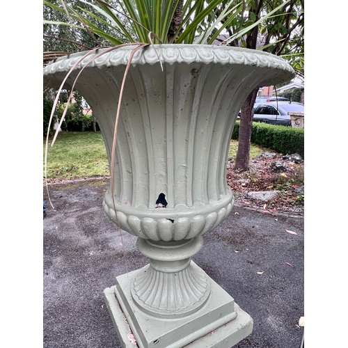 8 - A 19thC cast iron garden urn on reconstituted stone base. 153cm h x 67cm d to top of urn.