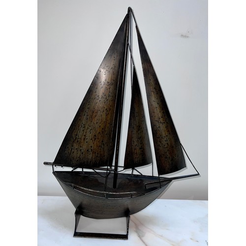 1346 - A metal model sailing boat. 78cm h x 59cm w.