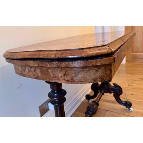 123 - A 19thC burr walnut fold over card table on ceramic castors with baize lined interior. 72cm h x 96cm... 