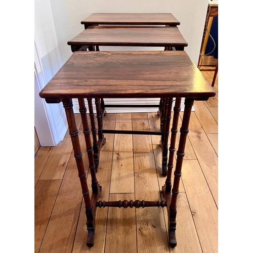 124 - A nest of three rosewood tables. Tallest 71cm h x 50cm w x 37cm d.