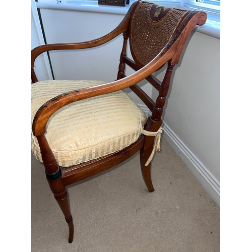 126 - A French style cane seated and painted armchair. Height to back 88cm x 55cm w.