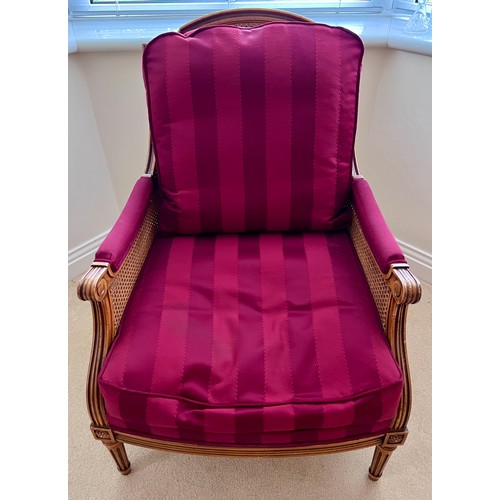 127 - A 20thC bergère armchair. Height to back 91cm x 69.5cmn d x 67cm d.