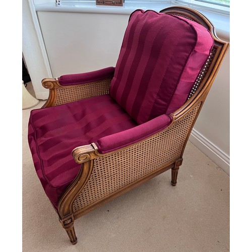 127 - A 20thC bergère armchair. Height to back 91cm x 69.5cmn d x 67cm d.