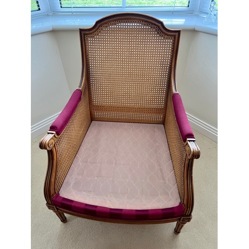 127 - A 20thC bergère armchair. Height to back 91cm x 69.5cmn d x 67cm d.