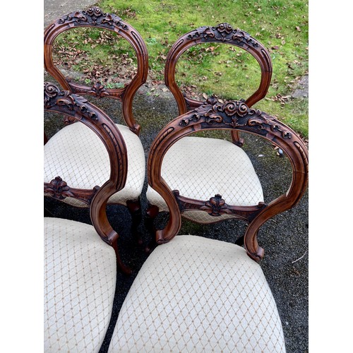 132 - A set of six 19thC walnut balloon backed dining chairs with carved crest rials and cabriole legs. He... 