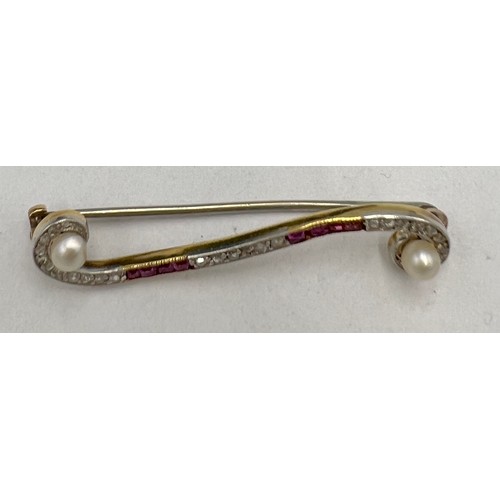 644 - A diamond and ruby bar brooch in unmarked yellow and white metal with pearl to each end. Weight 3.4g... 