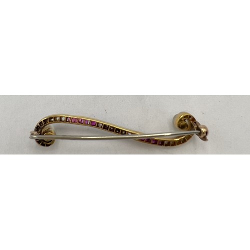 644 - A diamond and ruby bar brooch in unmarked yellow and white metal with pearl to each end. Weight 3.4g... 