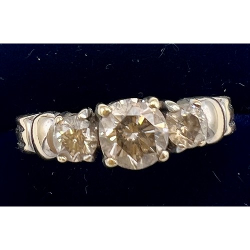 631 - A 14 carat gold and three stone diamond ring, size N/O. Weight 3.7gm.