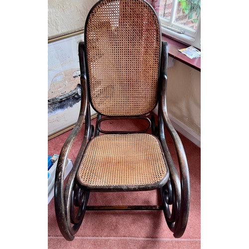 115 - A 19thC bentwood rocking armchair with cane back and seat.  Height to back 95cm .