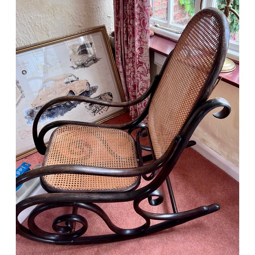 115 - A 19thC bentwood rocking armchair with cane back and seat.  Height to back 95cm .