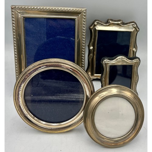 900 - Silver and plated photograph frames to include circular marked .800 11cm x 11cm, three hallmarked si... 