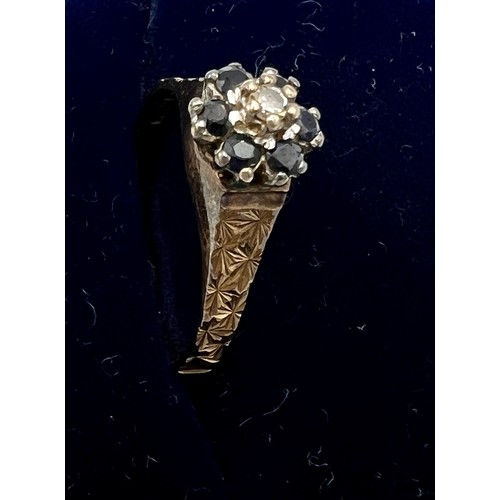 624 - A nine carat gold cluster ring with blue and clear gem stones. Size L. Weight 1.9gm.