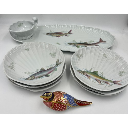 348 - A Limoges fish service comprising serving dish, six plates and a jug together with a Royal Crown Der... 