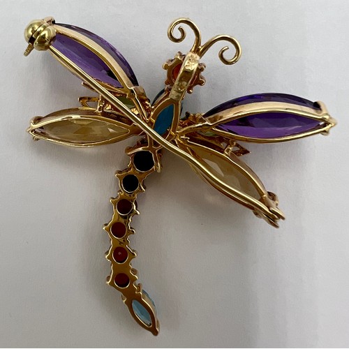 525 - A yellow metal gem set dragonfly brooch marked 14K. 4cm l. Weight 8.3gm.