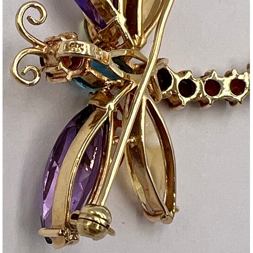 525 - A yellow metal gem set dragonfly brooch marked 14K. 4cm l. Weight 8.3gm.