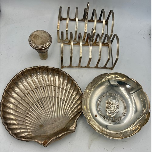 942 - Hallmarked silver to include a pair of toast racks, Winston Churchill dish, decanter stopper and a s... 