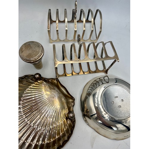 942 - Hallmarked silver to include a pair of toast racks, Winston Churchill dish, decanter stopper and a s... 