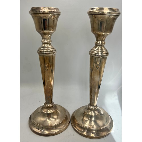 944 - A pair of silver candlesticks with filled bases. 23.5cm h. Sheffield 1978. Maker AT Cannon Ltd.