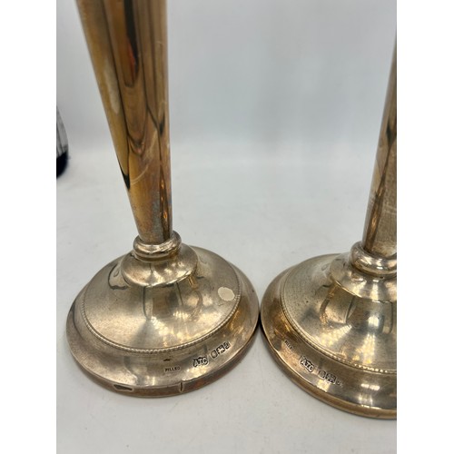 944 - A pair of silver candlesticks with filled bases. 23.5cm h. Sheffield 1978. Maker AT Cannon Ltd.