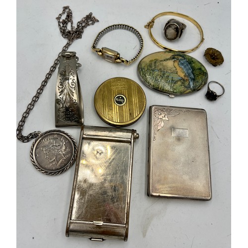 1354 - A miscellany to include vintage compacts, Victorian skirt lift, one dollar pendant, .900 silver ring... 