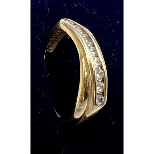 531 - A 9 carat gold ring set with clear stones. Size M. Weight 2gm.