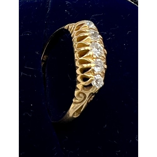 544 - A yellow metal ring, (marks rubbed) set with five diamonds. Size O. Weight 2.7gm.