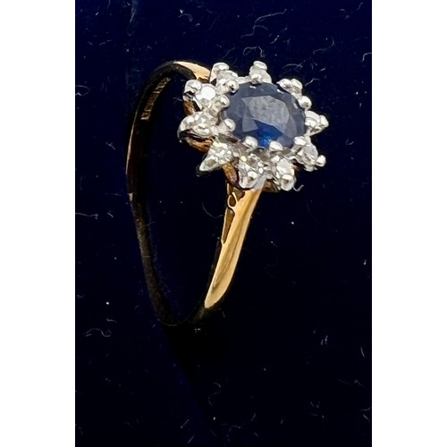 545 - An 18 carat gold sapphire and diamond cluster ring. Size M. Weight 2gm.