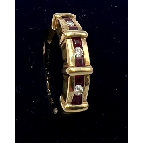 549 - A nine carat gold ring set with three diamonds and rubies. Size L. Weight 3.1gm.