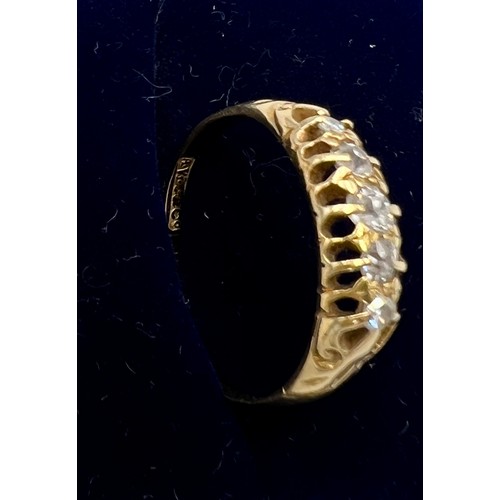 554 - An 18 carat gold ring set with five diamonds. Size P. Weight 2.6gm.