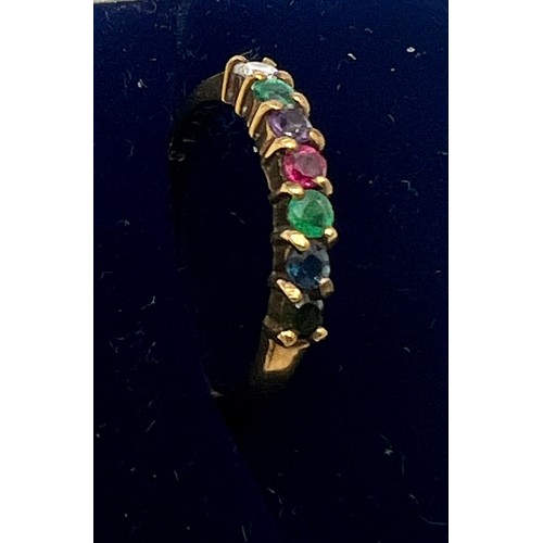 556 - A 9 carat gold ring set with multi coloured gem stones. Size N, weight 1.9gm.