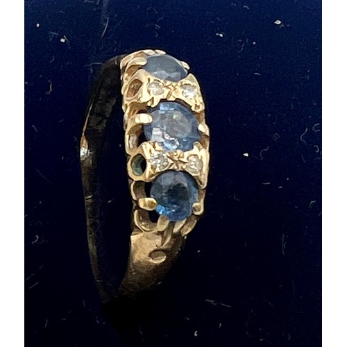 559 - A 9 carat gold ring set with blue and clear stones. Size N. Weight 1.6gm.