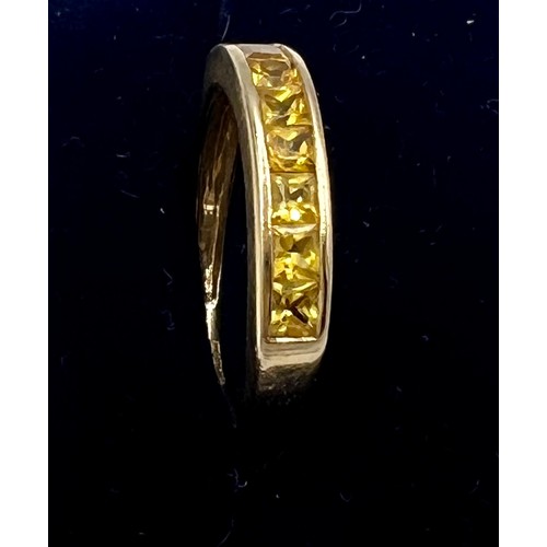 563 - A nine carat gold ring set with yellow stones. Size N, weight 1.9gm.