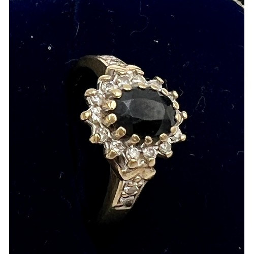 570 - A nine carat gold cluster ring set with blue and clear stones. Size M. Weight 3gm.