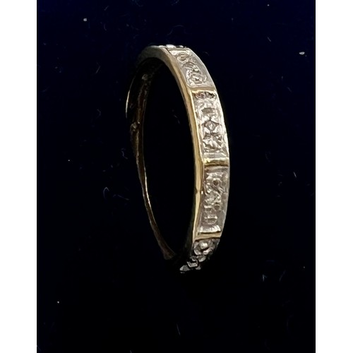 574 - A 9 carat gold eternity ring set with clear stones. Size M. Weight 1.2gm.