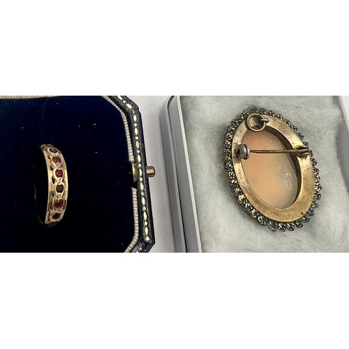 575 - A 9 carat gold ring set with pink stones, size O. Weight 1.2gm together with a carved shell cameo br... 